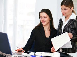 ladies behind a laptop